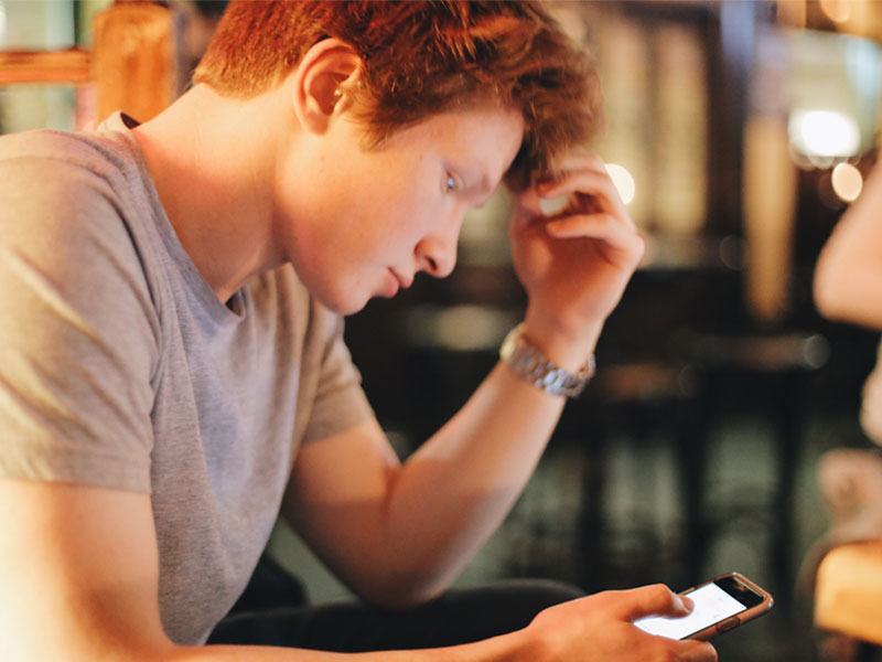 A guy on his phone because he's nervous about a first date.
