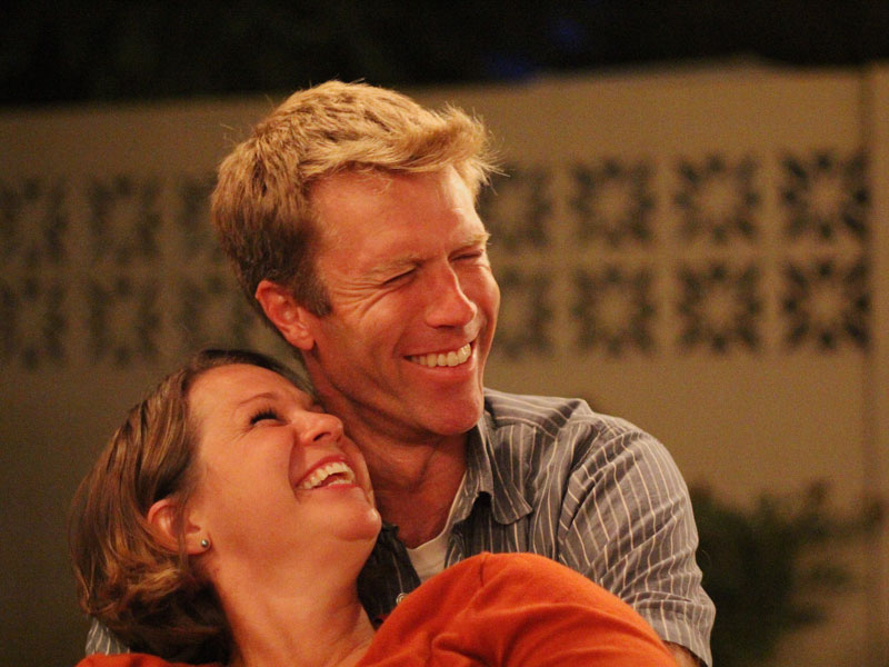 A couple in a healthy relationship smiling and laughing together.