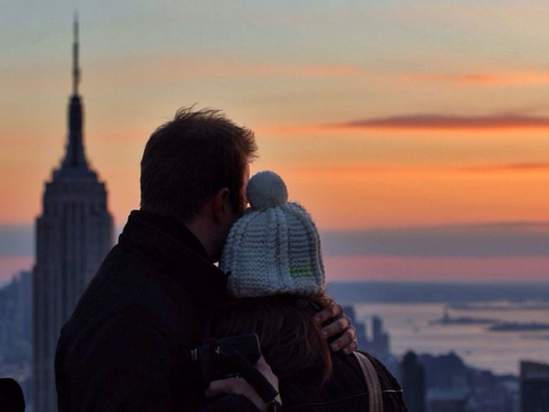 A couple cuddling while traveling together.