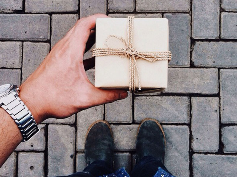 A man at a good state in his relationship giving a gift.