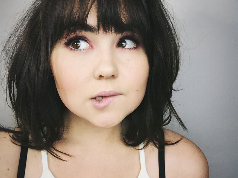 A woman who is making a nervous face because she's about to go on a first date.