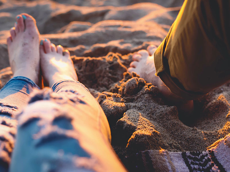 A woman dating an older man on the beach.