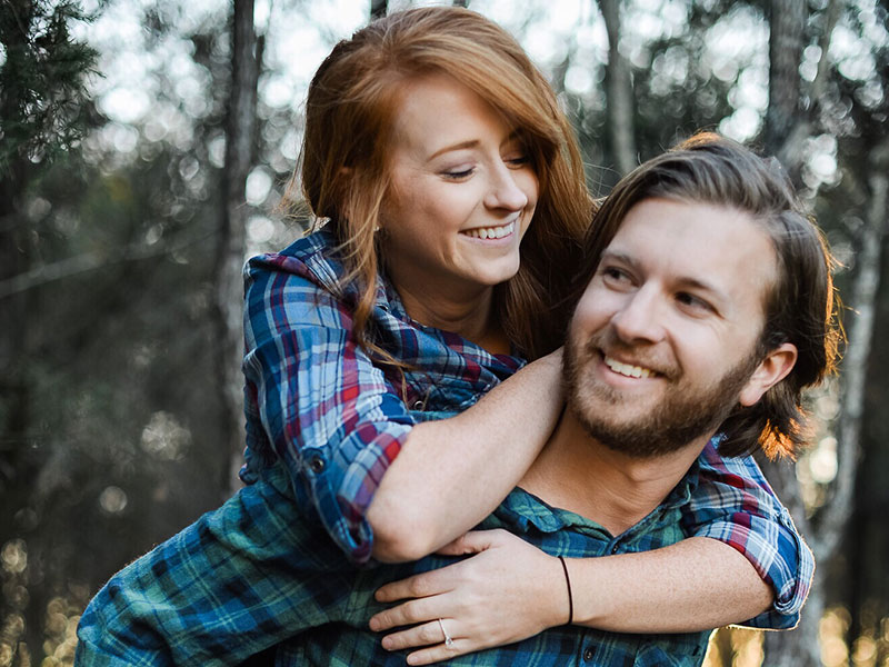 A couple who were friends before having a relationship laughing together.