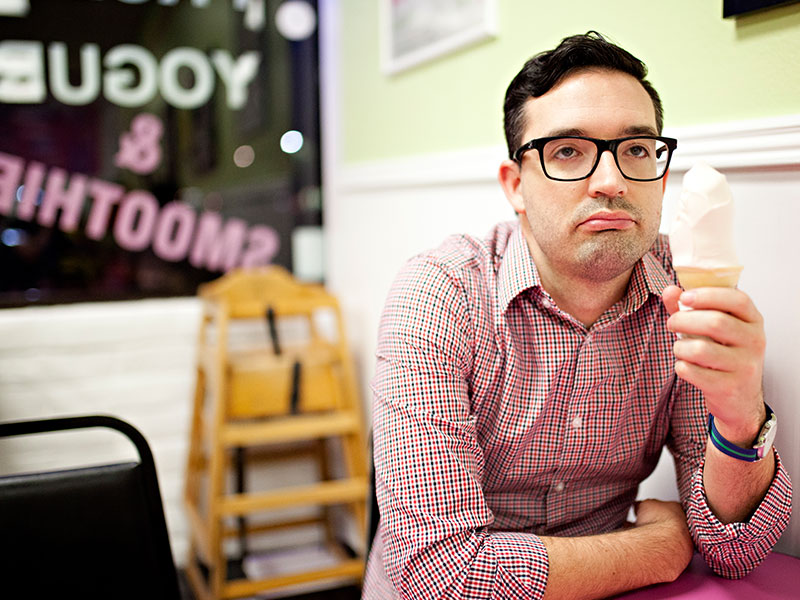A guy who looks sad while eating ice cream because sometimes being single sucks.