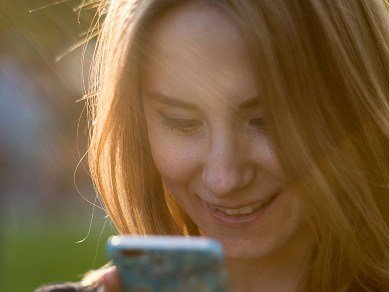 A woman sending an online dating message to a man.