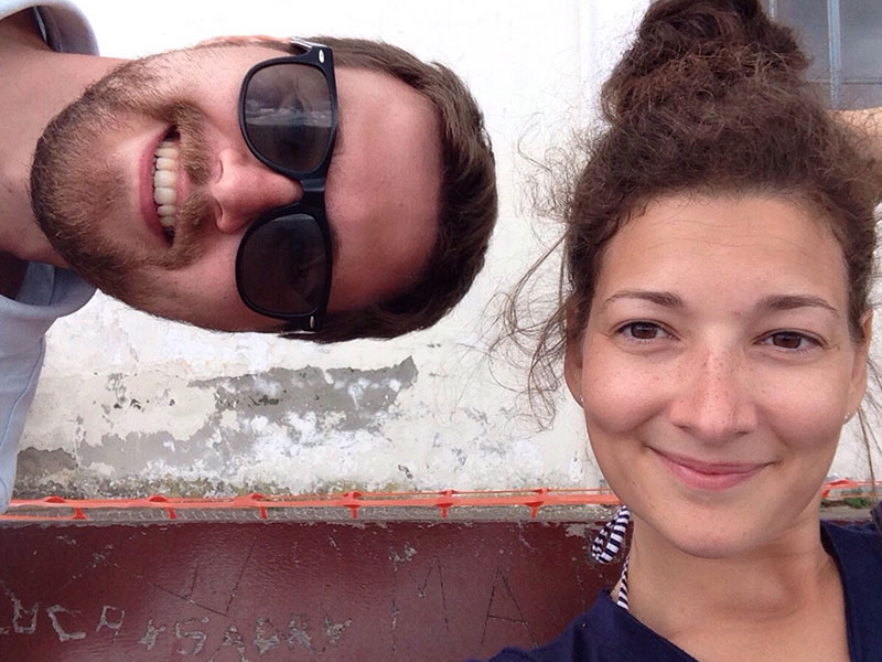 Two people who learned how to stay friends with an ex smiling together and being silly.