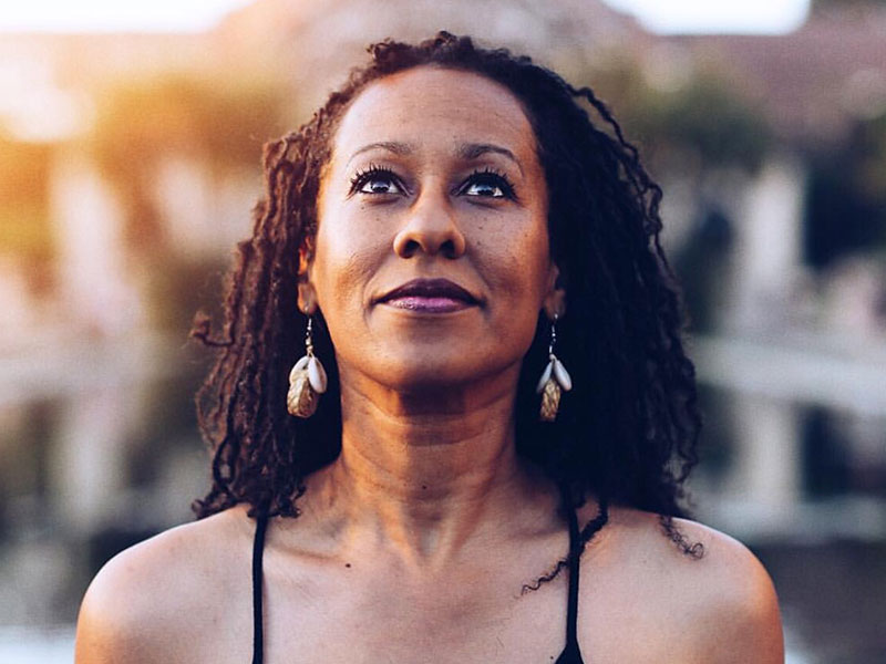 This strong woman is getting over heartbreak as she looks up into the sky.