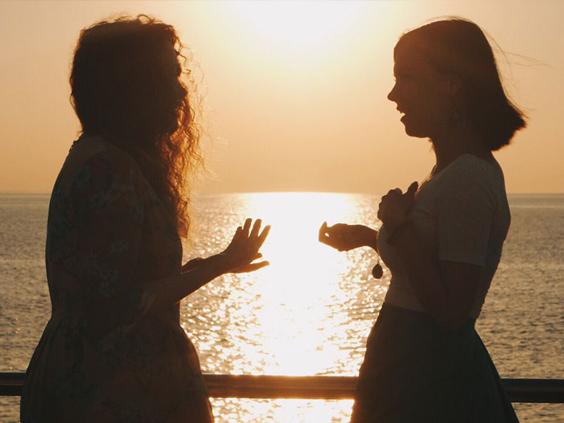 A woman telling her girlfriend I need space in a conversation on a pier.