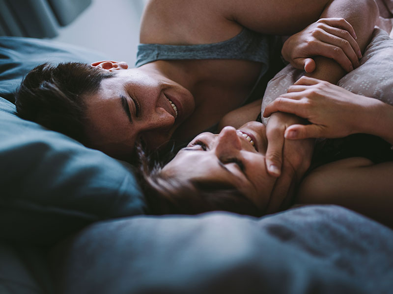 A man snuggling a woman in bed wondering what type of dater you are.