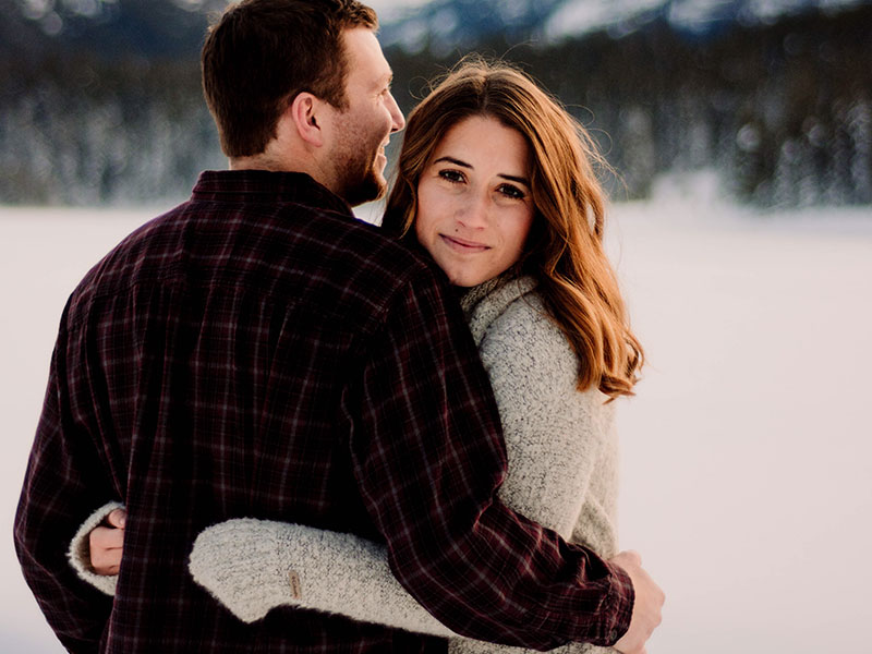 A woman who used online matchmaking and matchmaking services to snag the man she's hugging in the snow.