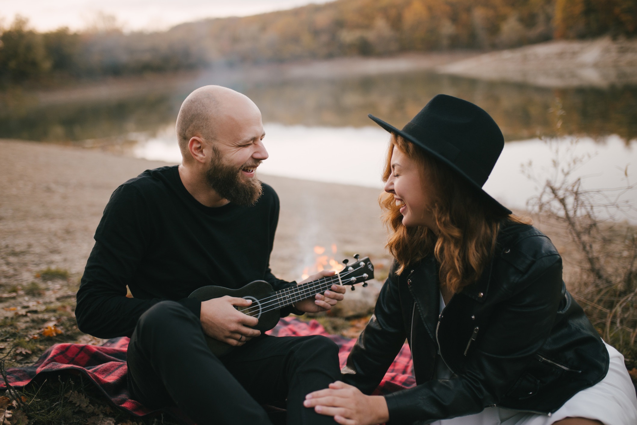 couple laughing and singing with guitar