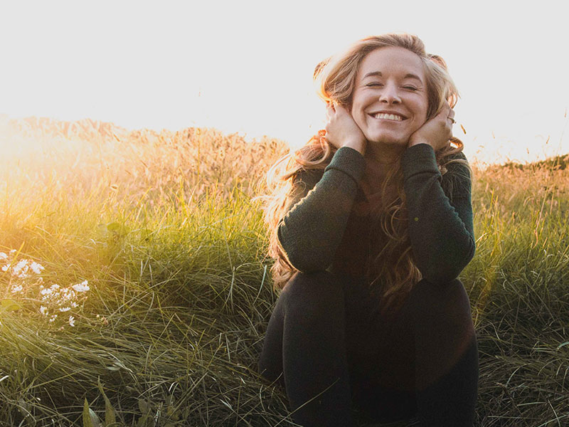 A girl who learned how not to care what someone thinks of your smiling in a meadow.