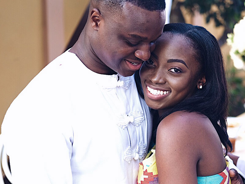 A man who learned how to woo a woman, hugging her and smiling and she looks up and smiles while hugging him back.