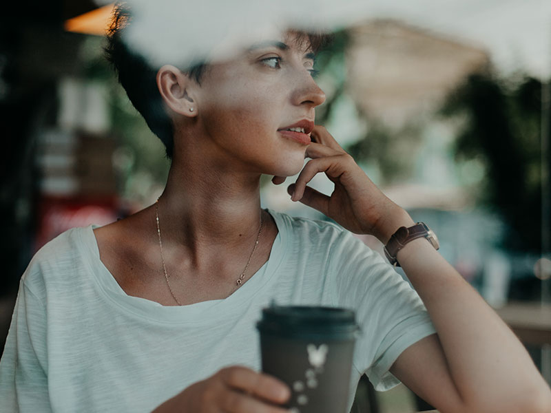A woman who need to know how to know when to break up, thinking as she sips her coffee and looks out the window.