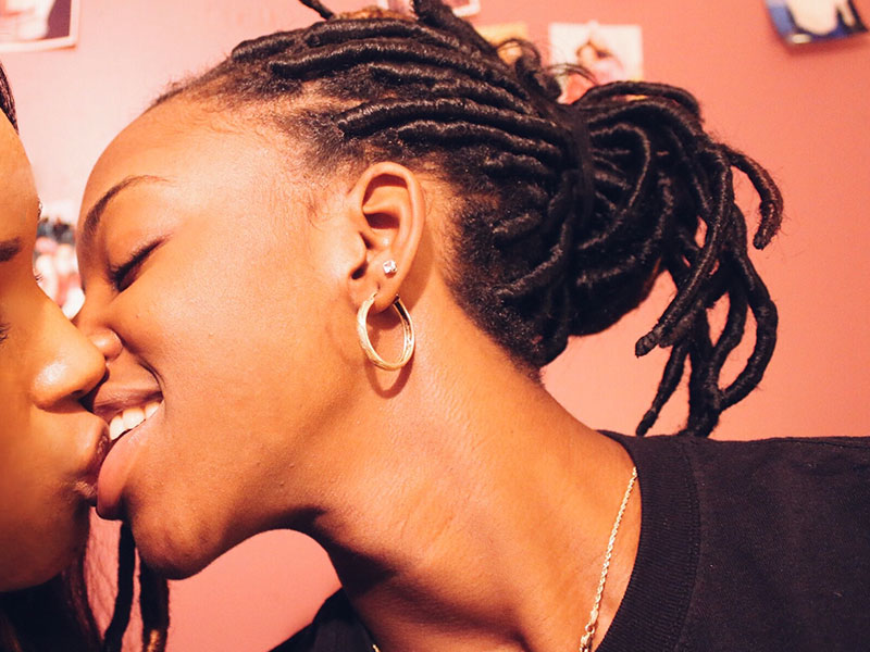 A woman who identifies as bi-curious, moving in to kiss another woman.