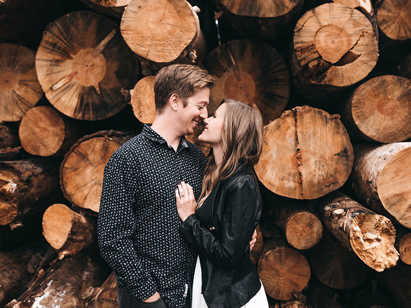A woman who things chivalry is not dead kissing her boyfriend outside.