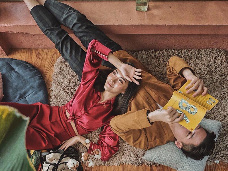 A couple playing one of these games for couples as they lay on the floor at home.