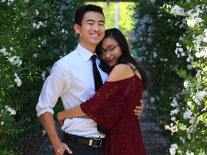 A guy who knows how to be a gentleman getting a hug from his date at a wedding.