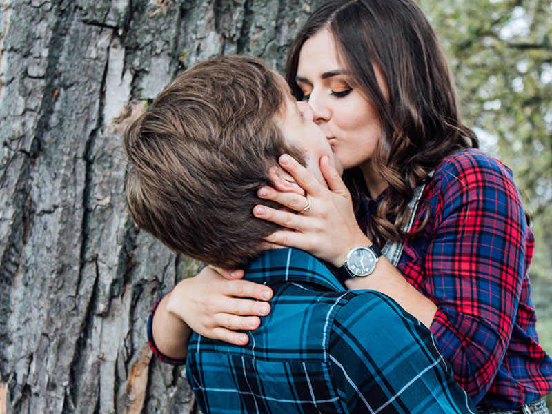 A man who used one of these things I love about you to compliment his girlfriend, kissing her outside under a tree.