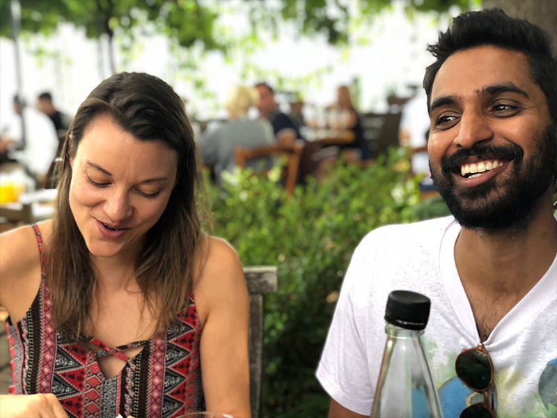 A couple who used to date but are now just friends laughing and talking over lunch.