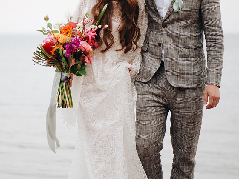 A couple who met online dating getting married on the beach.