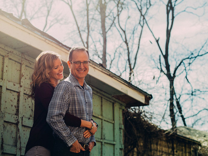 A man and a woman hugging. Both of them look happy and confident.