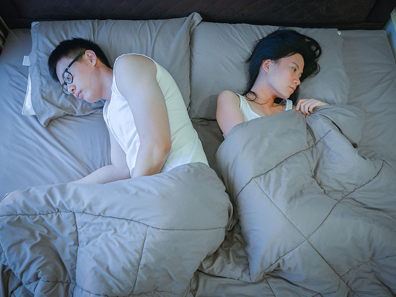 A women who knows we both cheated on each other in bed next to her husband, wondering what to do.