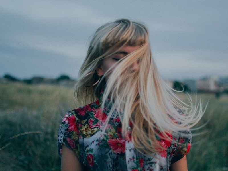 single attractive girl walking in the outdoors celebrating letting go and moving on