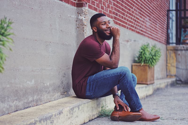 attractive single man sat on a step