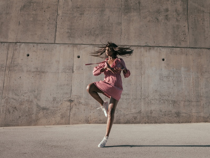 beautiful woman dancing in front of all saying yes to am I attractive