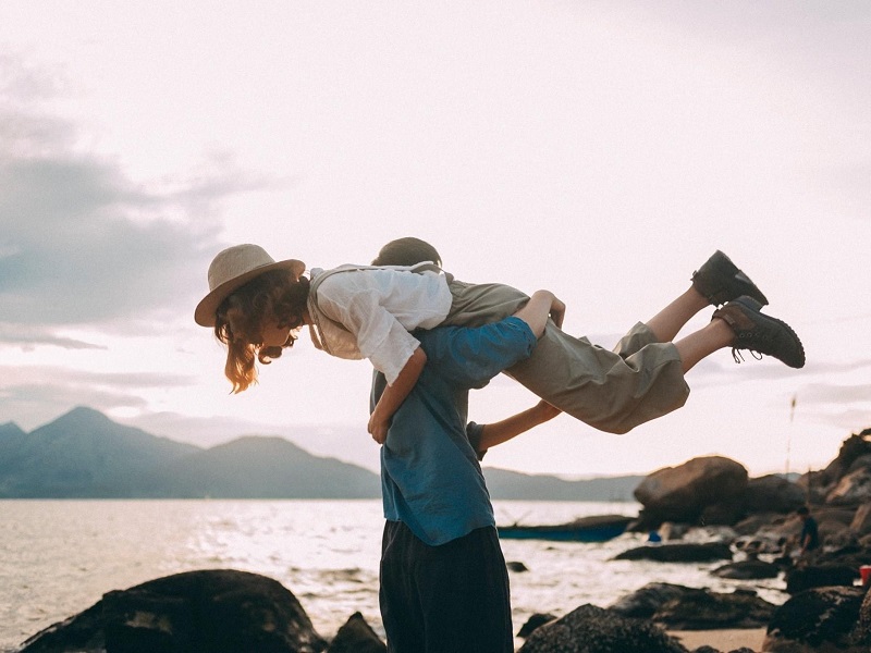 young couple on beach showing what it is to love someone