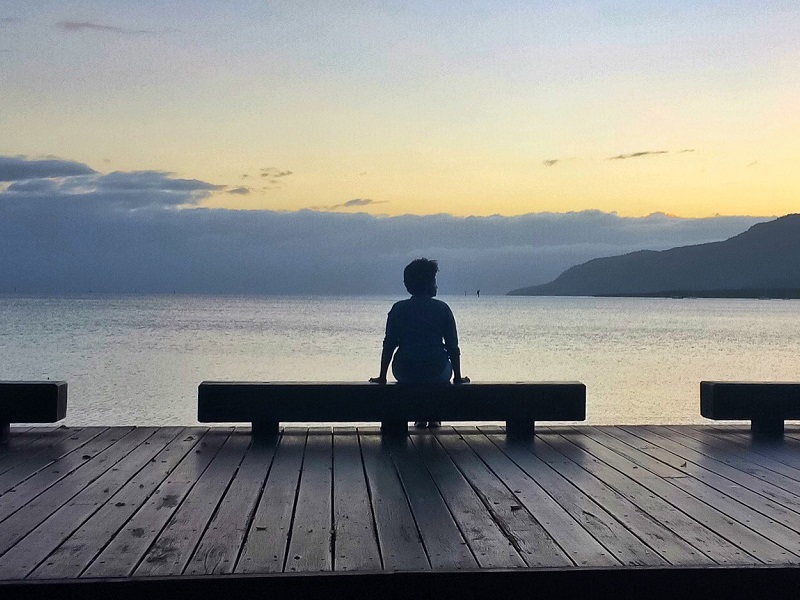 person-sitting-on-a-pier-thinking-of-sad-relationship-quotes
