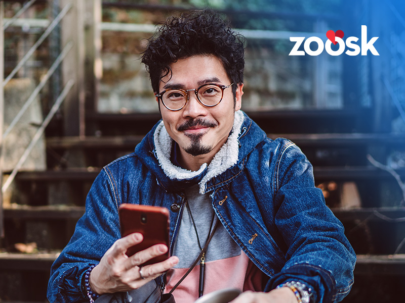 attractive man using his mobile for Zoosk sign up