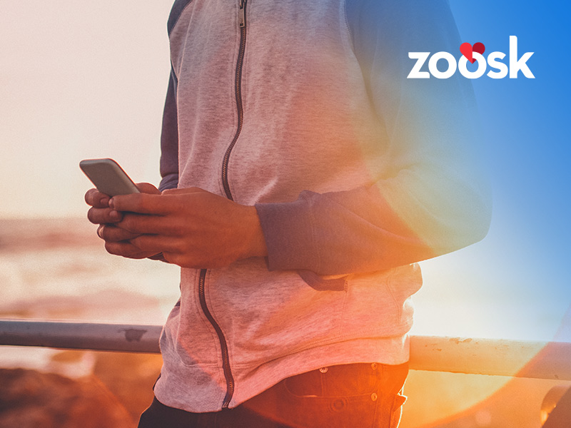 man-using-his-phone-to-determine-zoosk-cost