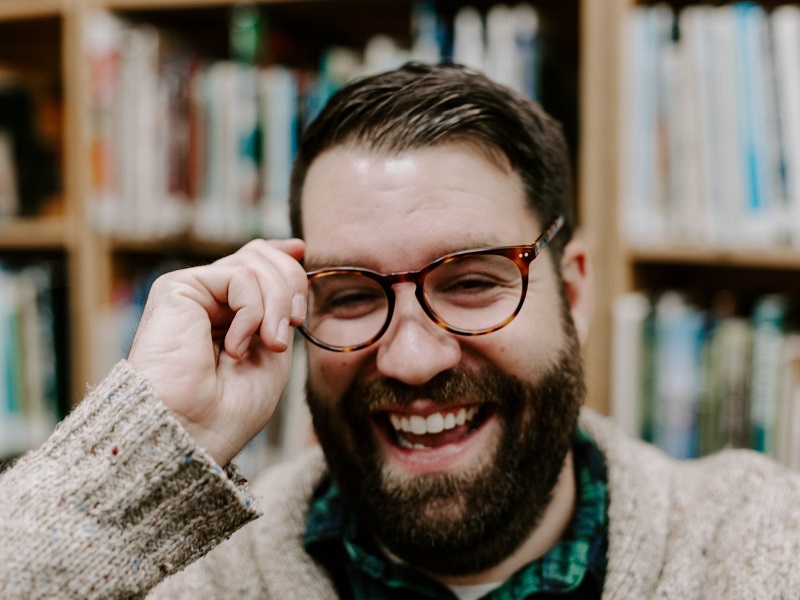 man laughing after being asked a funny question to ask a guy