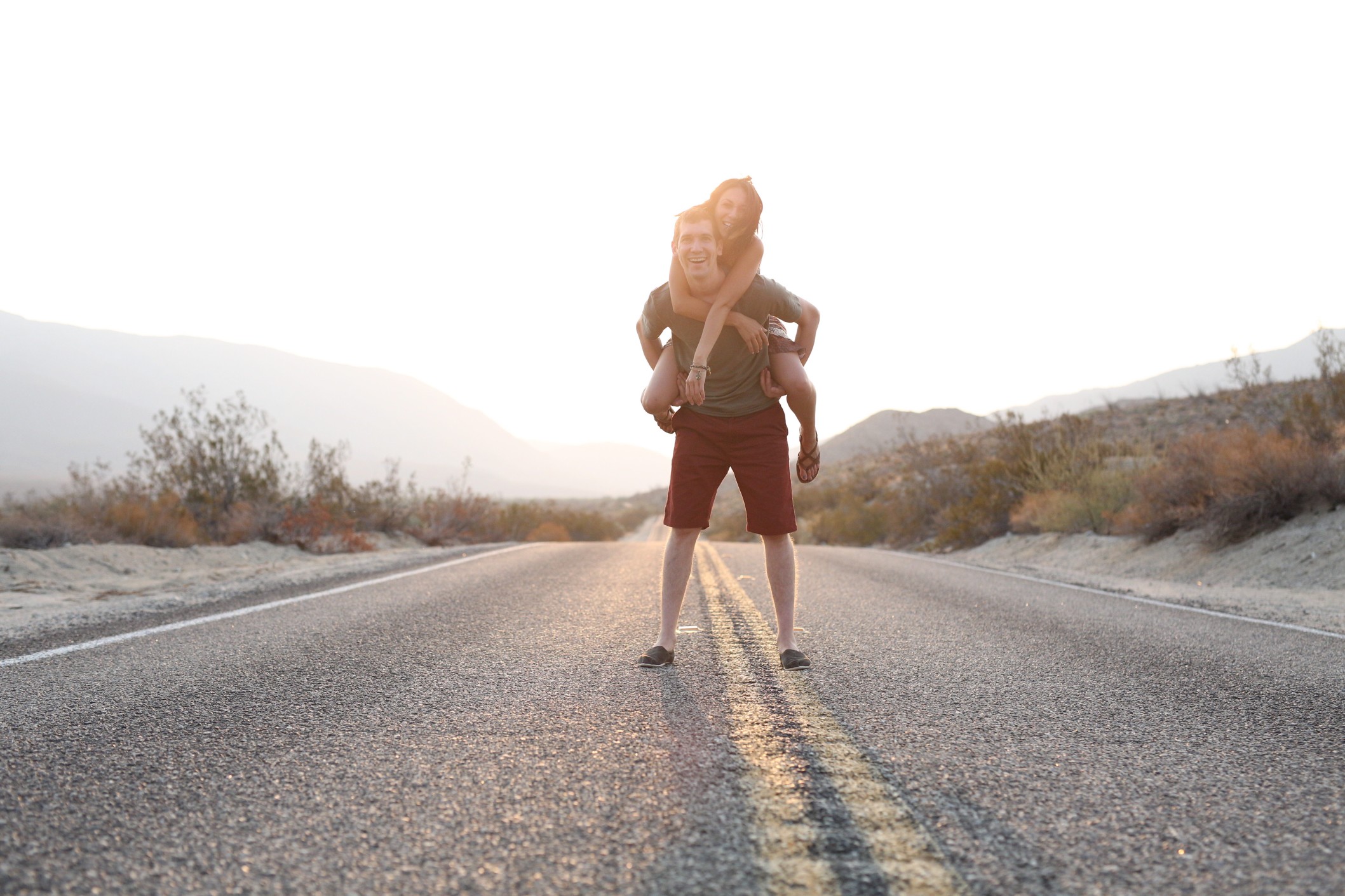 Happy couple standing in the road laughing outside Phoenix