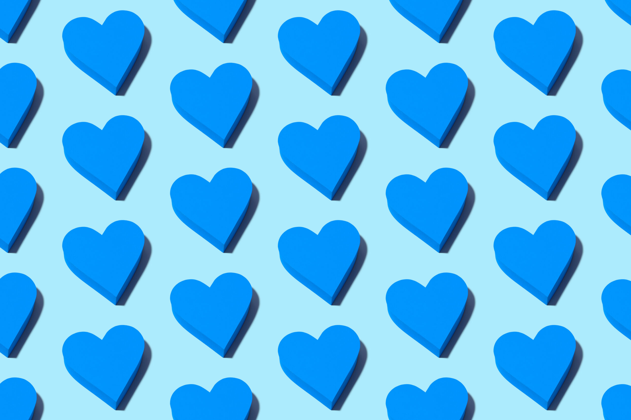 Illustration of multiple blue love hearts on blue backgrounds to represent love bombing signs and how to tackle them.